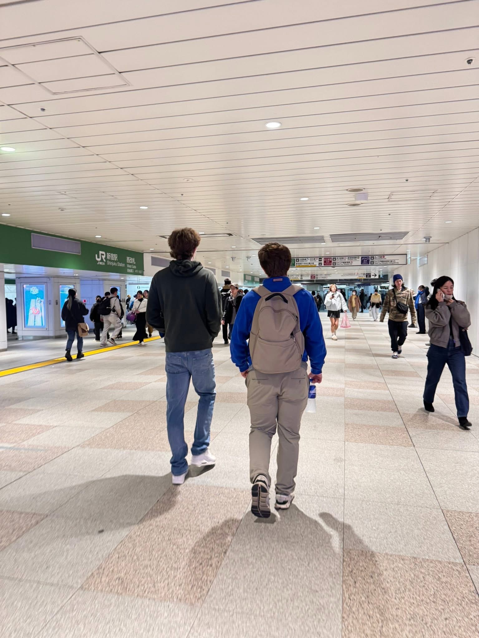 Boys walking in Shinjuku Station